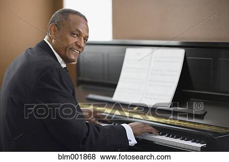African man playing piano View Large Photo Image Stock Photo - African man playing piano. Fotosearch