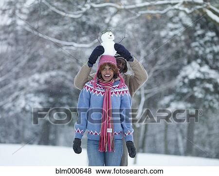 African man putting miniature snowman on girlfriendÆs head View Large Photo Image Stock Photo - African man putting miniature snowman on girlfriendÆs head. Fotosearch