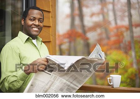 African man reading newspaper outdoors View Large Photo Image Stock Photograph - African man reading newspaper outdoors. Fotosearch