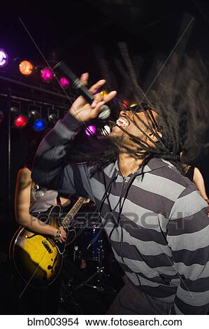 African man singing and dancing onstage View Large Photo Image Picture - African man singing and dancing onstage. Fotosearch