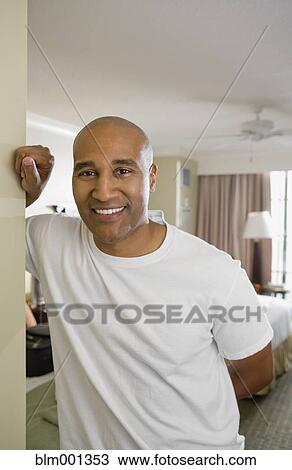 Stock Image - African man smiling in doorway. Fotosearch