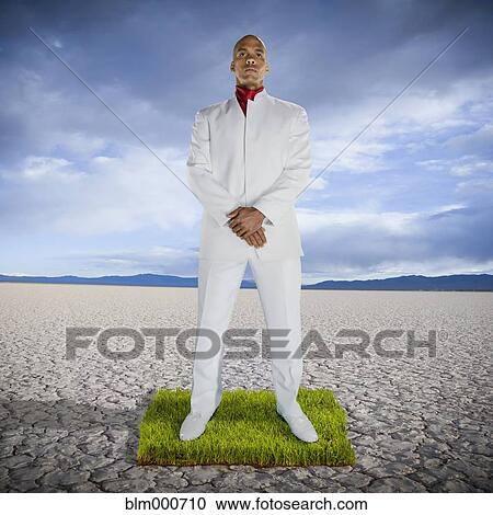 African man standing on patch of grass in desert View Large Photo Image Stock Image - African man standing on patch of grass in desert. Fotosearch
