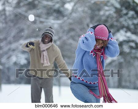 African man throwing snowball at girlfriend View Large Photo Image Stock Photograph - African man throwing snowball at girlfriend. Fotosearch