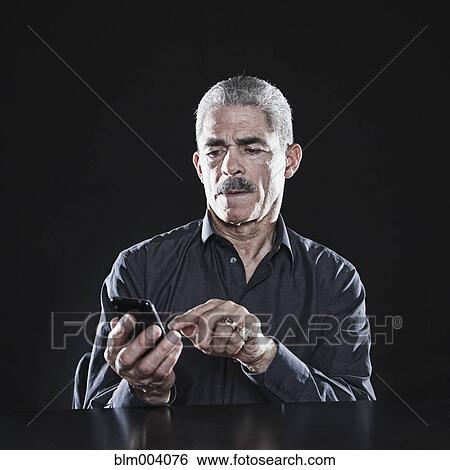Stock Photograph - African man using cell phone. Fotosearch