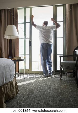 Picture - African man wearing pajamas in morning. Fotosearch