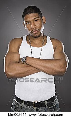 Picture - African man with arms crossed. Fotosearch