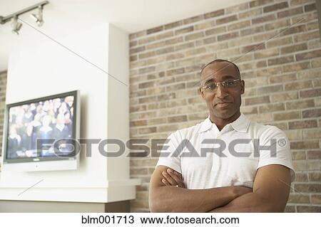 Stock Image - African man with arms crossed. Fotosearch