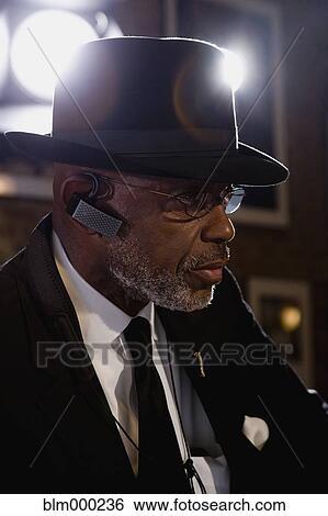 Stock Photograph - African man with hands-free cell phone device. Fotosearch