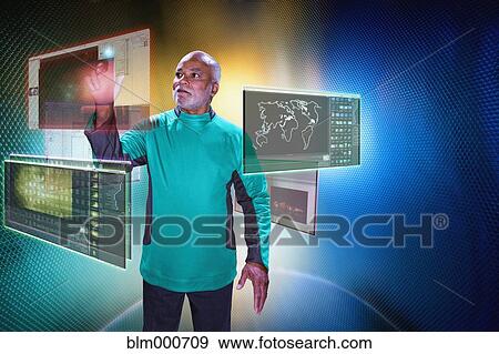 Stock Photo - African man working at futuristic control panel. Fotosearch