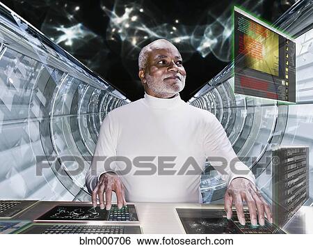 Stock Photograph - African man working at futuristic control panel. Fotosearch