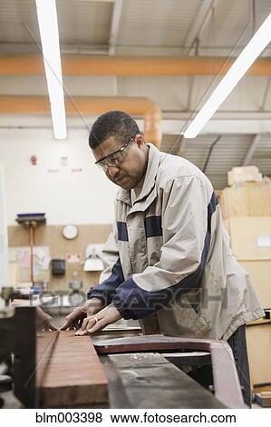 Stock Photo - African man working in workshop. Fotosearch