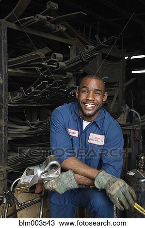 Stock Image - African mechanic in repair shop. Fotosearch