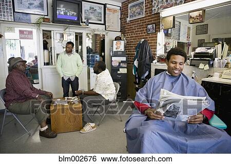 Stock Photograph - African men in barber shop. Fotosearch