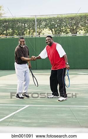 African men playing doubles tennis View Large Photo Image Stock Image - African men playing doubles tennis. Fotosearch