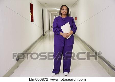 Stock Image - African nurse in hospital corridor. Fotosearch