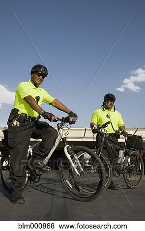 Stock Photo - African police officers on bicycles. Fotosearch