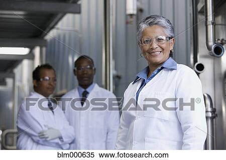 Stock Photography - African scientists standing in factory. Fotosearch