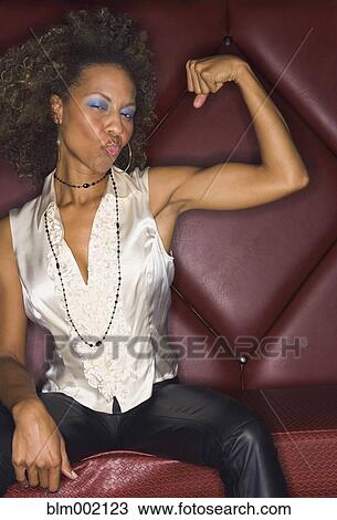 African woman flexing biceps and blowing kiss View Large Photo Image Stock Image - African woman flexing biceps and blowing kiss. Fotosearch