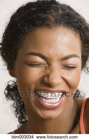 Picture - African woman grimacing and smiling. Fotosearch