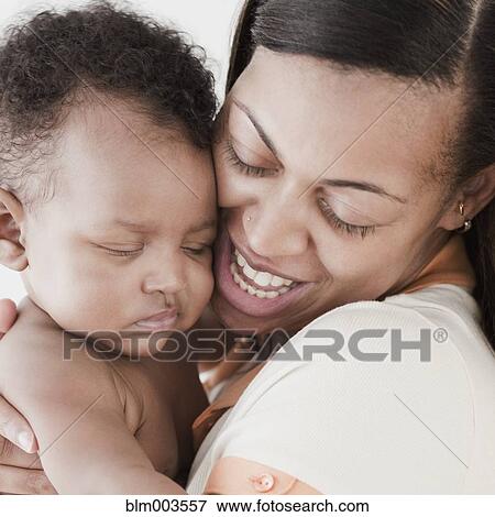 African woman hugging baby View Large Photo Image Stock Photo - African woman hugging baby. Fotosearch