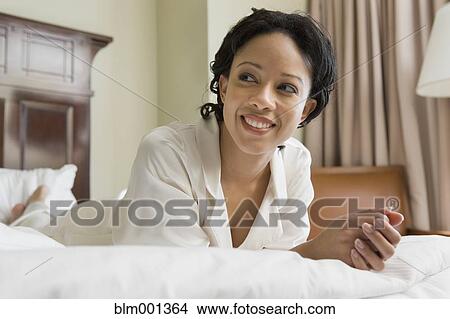 African woman laying on bed View Large Photo Image Picture - African woman laying on bed. Fotosearch