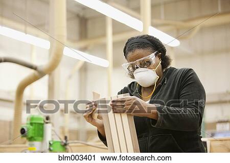 African woman sanding wood in workshop View Large Photo Image Stock Image - African woman sanding wood in workshop. Fotosearch