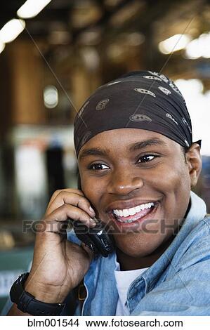 African woman talking on cell phone View Large Photo Image Picture - African woman talking on cell phone. Fotosearch