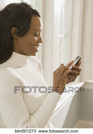 African woman using cell phone View Large Photo Image Stock Image - African woman using cell phone. Fotosearch