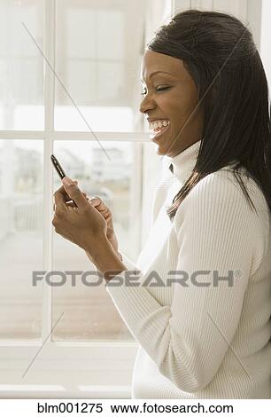 African woman using cell phone View Large Photo Image Stock Photography - African woman using cell phone. Fotosearch