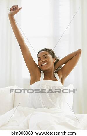African woman waking up in bed View Large Photo Image Stock Image - African woman waking up in bed. Fotosearch
