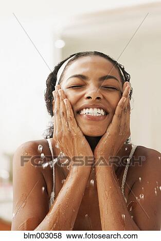African woman washing face View Large Photo Image Stock Photo - African woman washing face. Fotosearch