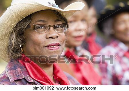 Stock Image - African woman wearing cowboy hat. Fotosearch