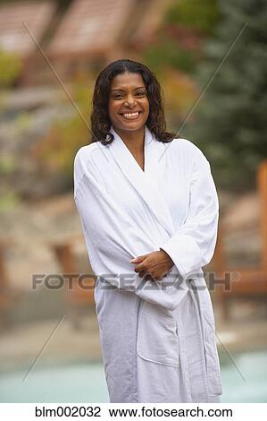 Stock Image - African woman wearing spa bathrobe. Fotosearch