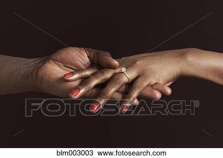 African woman with engagement ring holding fiancee's hand View Large Photo Image Stock Image - African woman with engagement ring holding fiancee's hand. Fotosearch