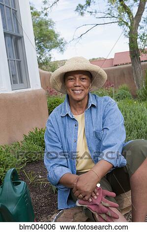 African woman working in garden View Large Photo Image Stock Photograph - African woman working in garden. Fotosearch