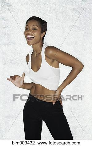 Stock Image - Alluring African woman in sportswear. Fotosearch