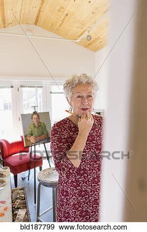 Stock Photo - Artist painting in studio. Fotosearch