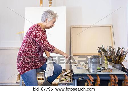 Stock Photography - Artist painting in studio. Fotosearch