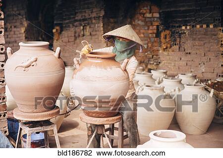Artist painting pots in factory View Large Photo Image Stock Image - Artist painting pots in factory. Fotosearch