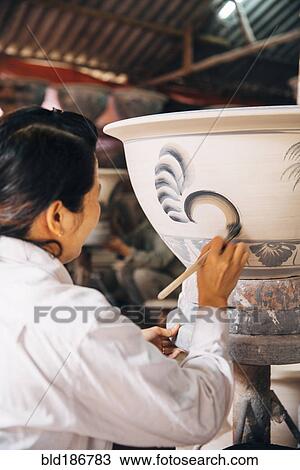 Artist painting pots in studio View Large Photo Image Stock Image - Artist painting pots in studio. Fotosearch