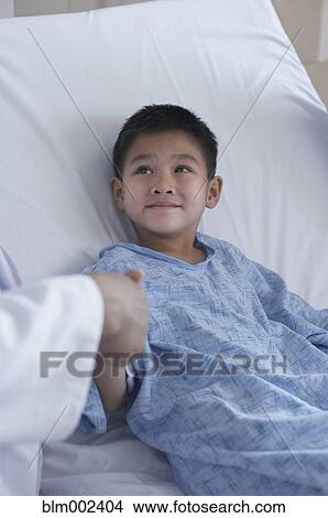 Asian boy shaking hands with doctor View Large Photo Image Picture - Asian boy shaking hands with doctor. Fotosearch