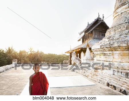 Stock Photo - Asian boy smiling outside temple. Fotosearch
