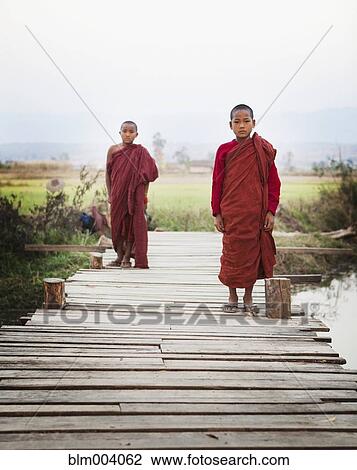 Asian boys in traditional robes walking on bridge Stock ...