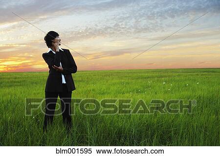 Asian businesswoman standing in field View Large Photo Image Stock Photography - Asian businesswoman standing in field. Fotosearch