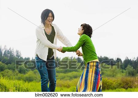 Stock Image - Asian couple holding hands. Fotosearch