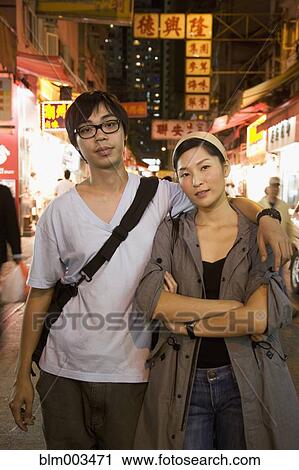 Asian couple hugging on urban street View Large Photo Image Stock Image - Asian couple hugging on urban street. Fotosearch