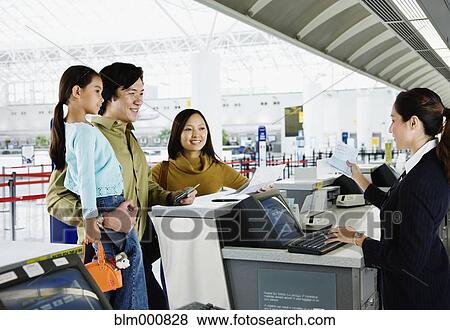 Asian family checking in at airport View Large Photo Image Stock Photo - Asian family checking in at airport. Fotosearch