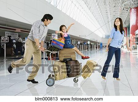 Asian family in airport View Large Photo Image Stock Image - Asian family in airport. Fotosearch