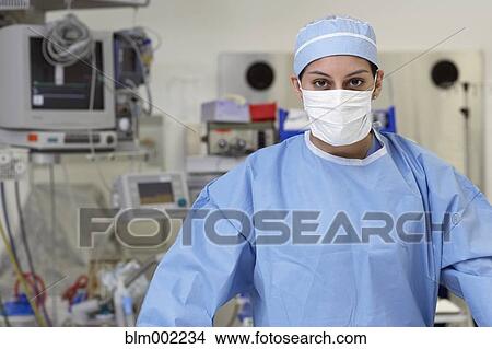 Picture - Asian female medical professional wearing surgical mask. Fotosearch