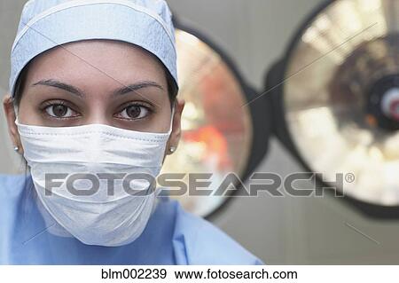 Stock Photo - Asian female medical professional wearing surgical mask. Fotosearch